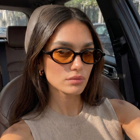 Jaxy Vinyl Oval sunglasses — worn view #Color_Black/Amber