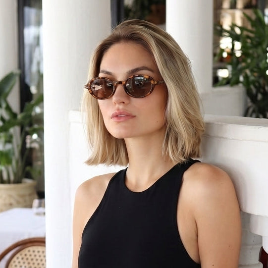 Jaxy Vinyl Oval sunglasses — worn view #Color_Tortoise