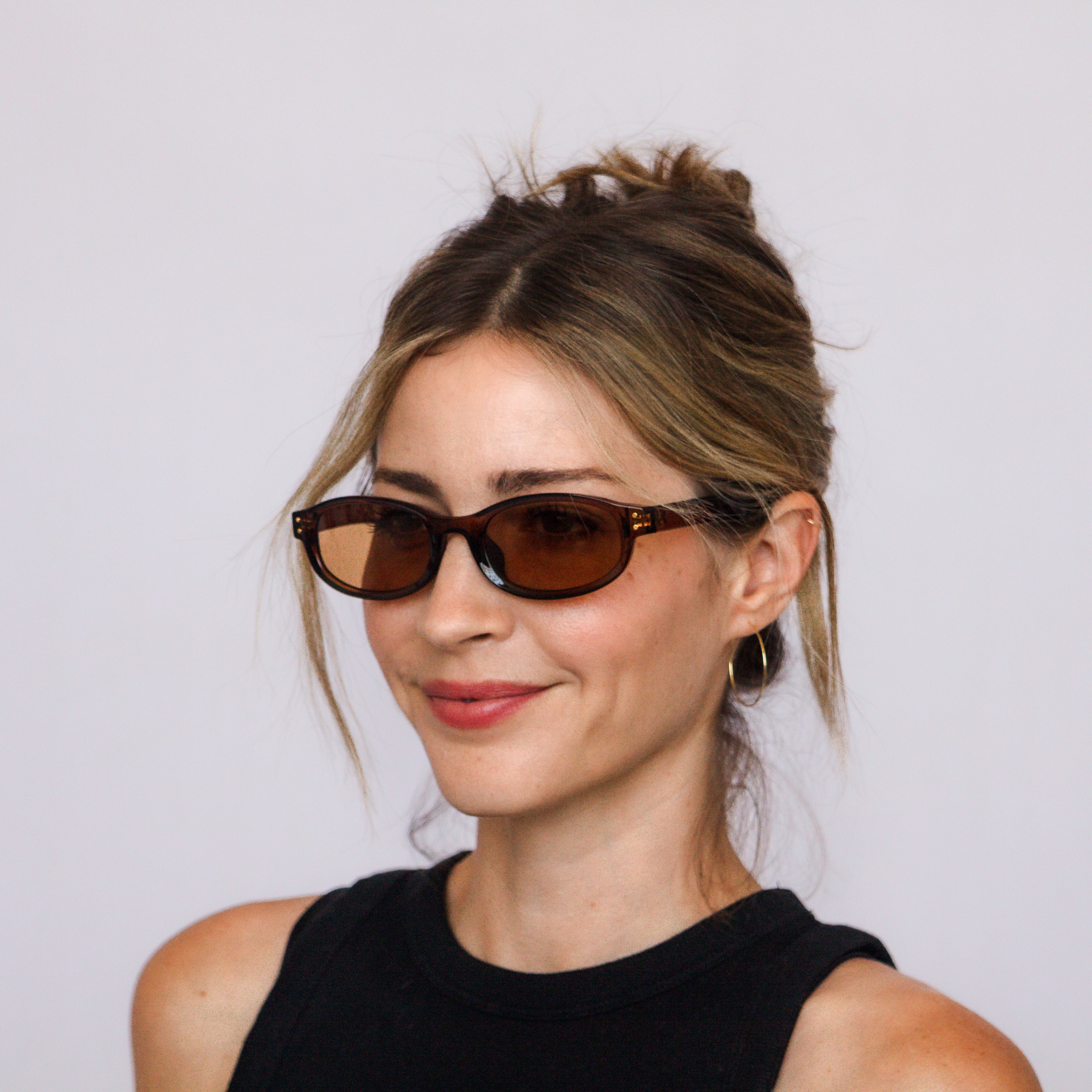A model in Jaxy Bardot oval sunglasses, lifestyle shot