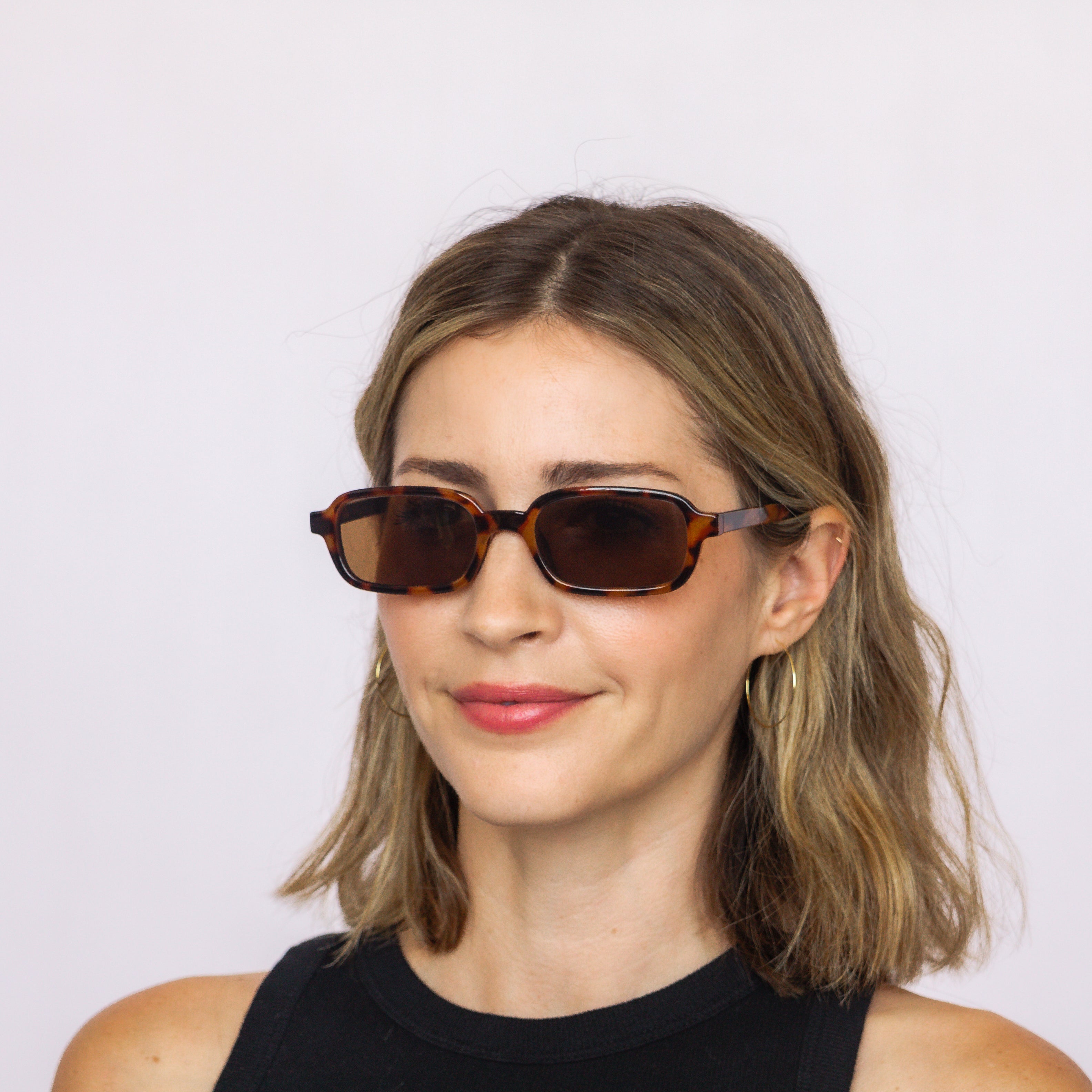 Jaxy Eyewear Velvet Hour – rectangle sunglasses worn by a model